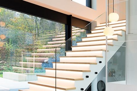 View of an illuminated oak parquet staircase