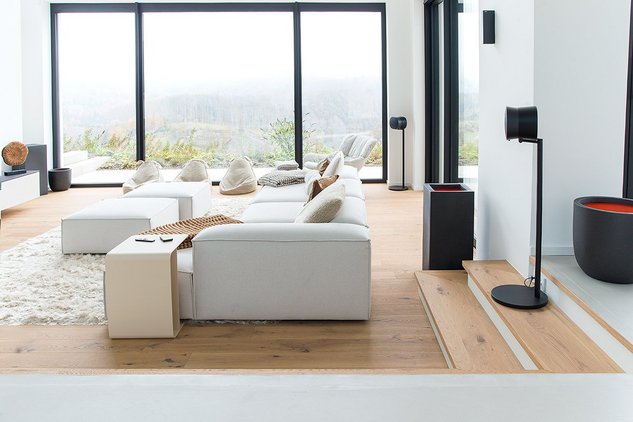 Minimalist living room with large windows, furnishings in white and black with white oiled oak parquet flooring