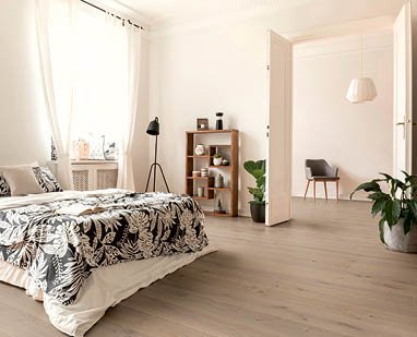 Bedroom in old apartment with gray parquet flooring