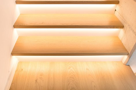 Detailed view of a wooden staircase with integrated LED lighting