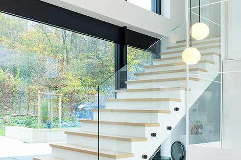 Staircase with modern staircase and glass railing
