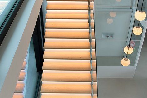 Bird's eye view of an illuminated wooden staircase 
